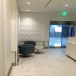 a lobby with a blue chair and a table