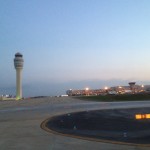 a runway with a tower in the distance