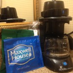 a coffee maker next to a bag of coffee