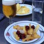 a plate of food and a glass of beer