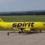 a yellow airplane on a runway