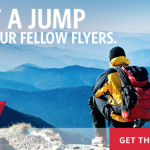 a person with a backpack looking at a mountain range