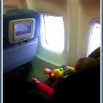 a baby sleeping on an airplane