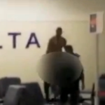 a blurry image of a man standing next to a person