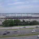 a large airport with many cars and a large building