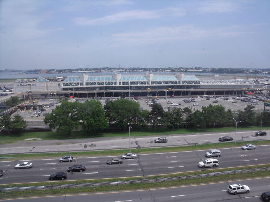 a large building with many cars on the road