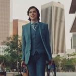 a man in a suit and tie holding luggage