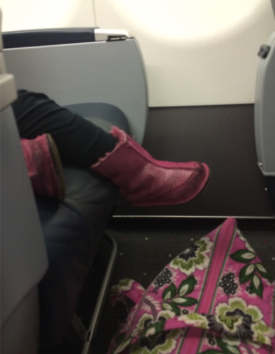 a person's feet in a pink boot