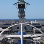 a tower with a white structure and a white roof