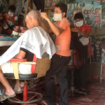 a man cutting a man's hair