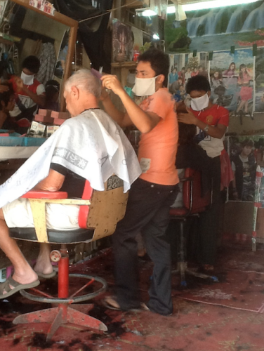 a man cutting a man's hair