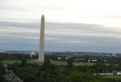 a tall white tower in a park