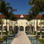 a building with palm trees and a walkway