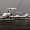 a group of airplanes on a runway