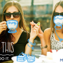 a couple of women sitting at a table with coffee cups drawn on them