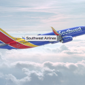 a blue red and yellow airplane in the sky