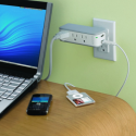 a laptop and cell phone plugged into a power outlet