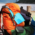 a backpack and mat on a dock