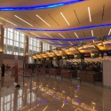 a large airport terminal with people waiting for their flight