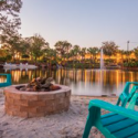 a fire pit and chairs on a beach