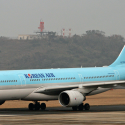 a blue airplane on a runway