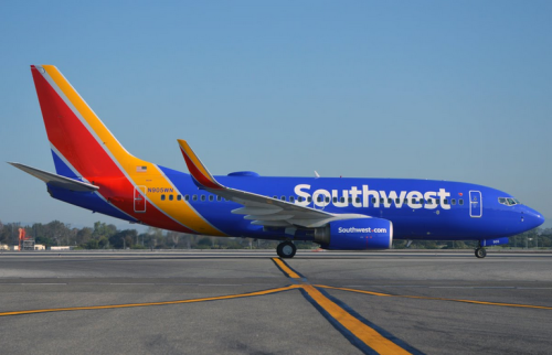 a blue and yellow airplane on a runway