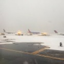 airplanes on a runway in the snow