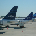 a group of airplanes parked at an airport