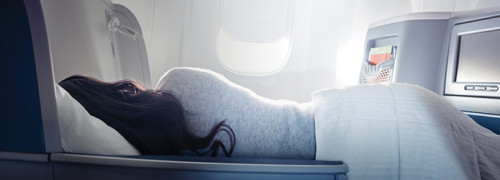 a woman lying on a plane