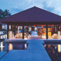 a gazebo with a pool in the background