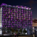 a large building with purple lights