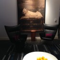 a room with a painting of a dog and oranges
