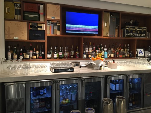 a bar with bottles of alcohol and a television
