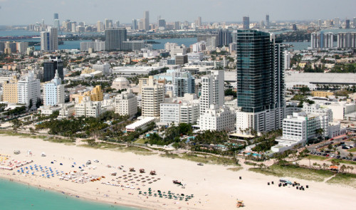 a city with many tall buildings and a beach