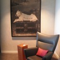 a chair and a poster on the wall