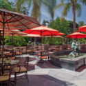 a patio with tables and umbrellas