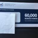 a blue and white check with a white receipt on a black surface