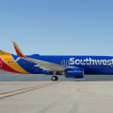 a blue and yellow airplane on a runway