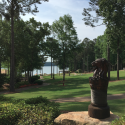 a statue of a lion on a rock in a park