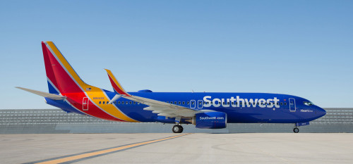 a blue and yellow airplane on a runway