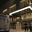 police officers standing next to a van
