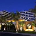 a building with palm trees and a fountain