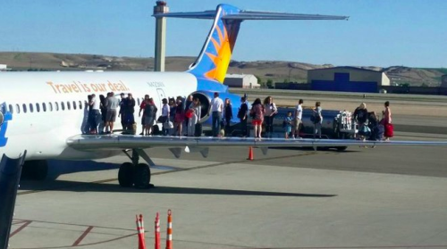 a group of people standing on an airplane