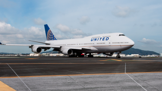 a large white airplane on a runway