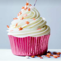 a cupcake with white frosting and stars sprinkles