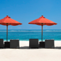 a group of chairs and umbrellas on a beach