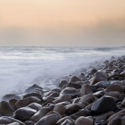 a rocky beach with waves crashing on it