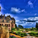 a large stone building with a circular garden