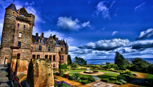 a large stone building with a circular garden