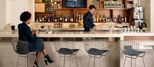 a man and woman standing at a bar